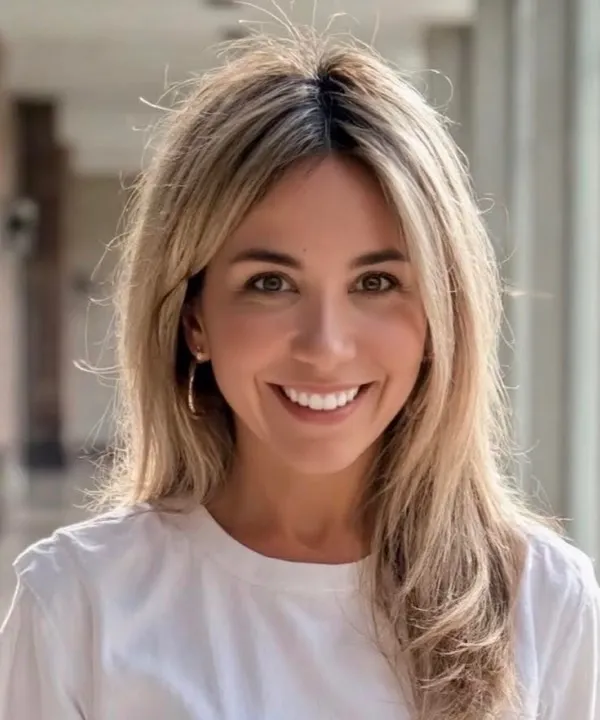 The founder of Cal + Clo Social, smiling, photographed outdoors in soft daylight.